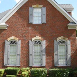 tall transom raised panel shutters with matching top panel on brick